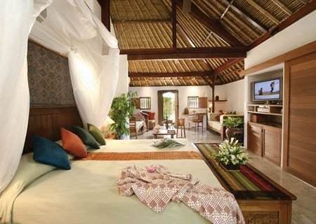 Heavenly retreat in Jimbaran Puri Bali offering a bedroom with a bed and a tv.