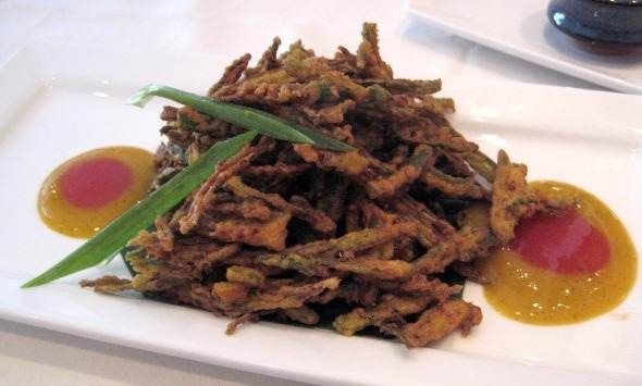 A plate of fried green beans on a white plate with an authentic Indian taste and in an Indian atmosphere at Amaya in London.