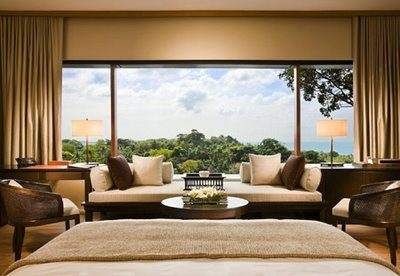 A bedroom with an ocean view, embodying the elegance of Colonial Manors.