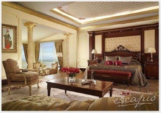 A large bedroom with ornate decor welcomes the guests at Mardan Palace.