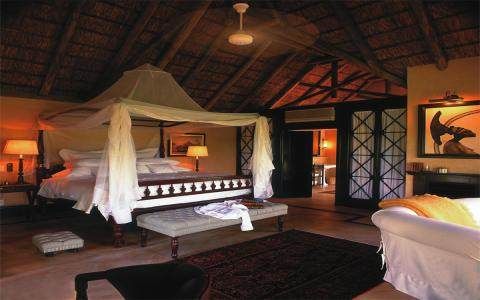 A bed in a Wild African room at Royal Malewane.