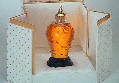 Caron's Poivre perfume bottle in a box with gold polka dots.
