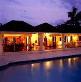A luxurious Montego Bay house with a mesmerizing swimming pool at dusk.