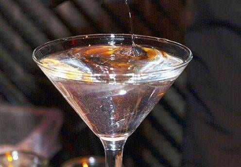 Flawless Christmas cocktail being poured into a glass for the elites.