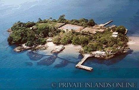 A small island paradise with a dock in the ocean.
