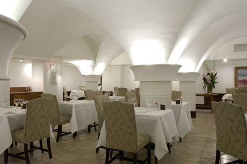 The Cellar - Dublin, Ireland: An arched dining room with white tables and chairs.