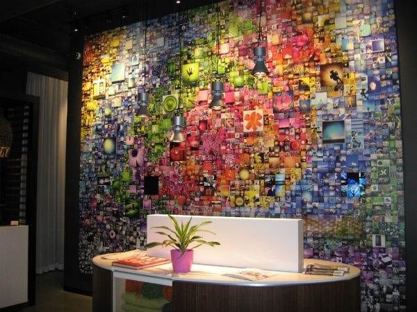 ALT Hotel Toronto: A vibrant office space showcasing a colorful wall adorned with photos.