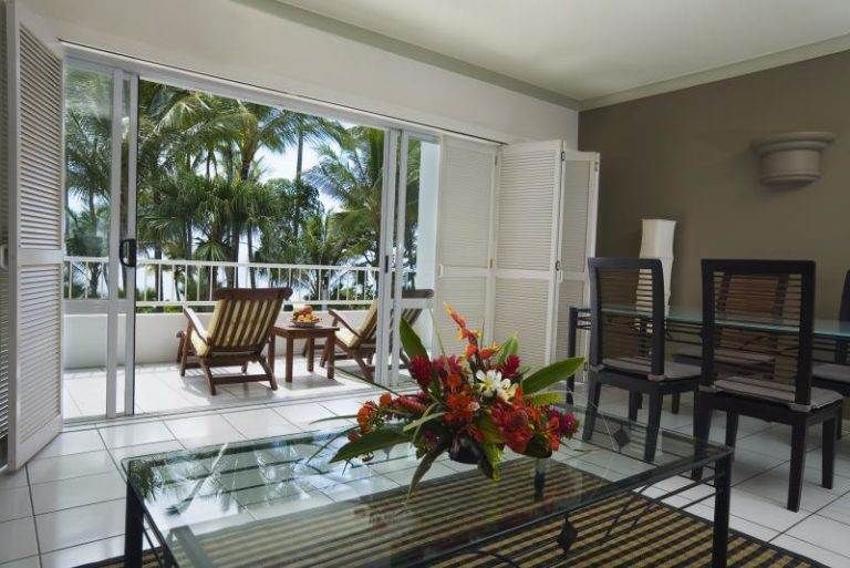 A living room with a balcony overlooking the Great Barrier Reef.