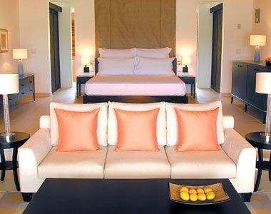 A room with couches and a coffee table in the Carlisle Bay.