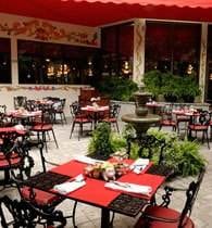 A Mexican-style restaurant with red tables and chairs.