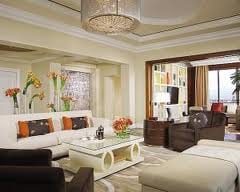 A glamorous living room in a hotel with a city view.