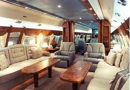 Luxurious interior of an airplane with couches and tables, perfect for conducting business.