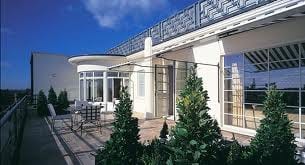 A balcony at The Brook Penthouse with a table and chairs in London.