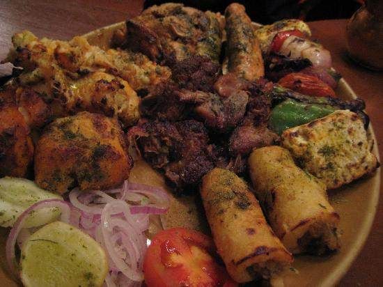 A plate with a variety of food on it, featuring authentic Indian flavors at Bukhara in New Delhi.