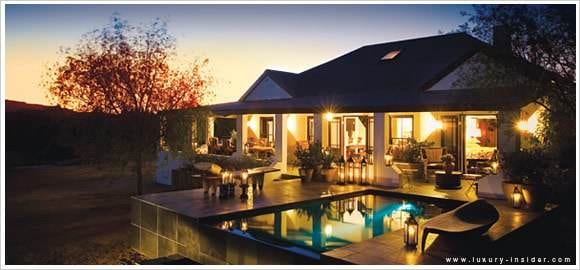 A house with a pool immersed in the wild beauty of nature.