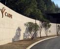 A stone wall with a sign that says YoYo care opens on April 1 in Napa.