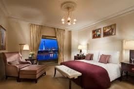 Treat Yourself to a Lavish Bedroom with Contemporary Décor and a River View at the Kempinski Nile Hotel.