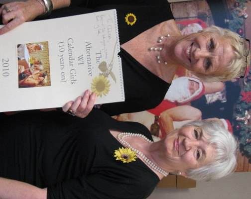 Two young women holding a certificate in front of a wall in Harrogate.
