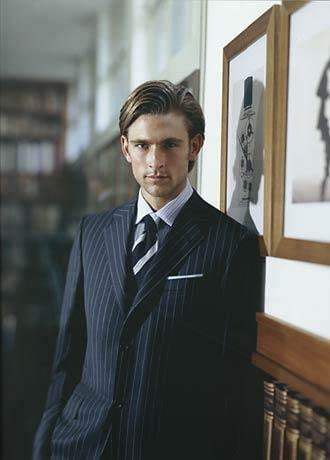 A man in a pinstripe suit exuding sophistication and style.