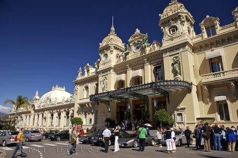 A group of people standing in front of an ornate building in Monte Carlo.