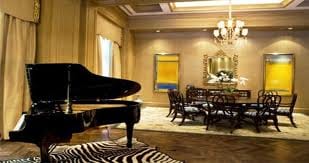 A living room in the Palazzo Resort with a piano and zebra print rug.
