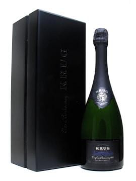 A bottle of Krug champagne next to a black box.