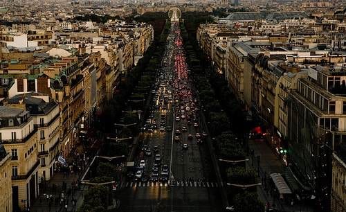 The Eiffel Tower can be seen from a city street.