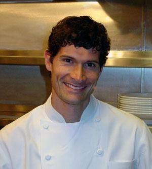 A man in a chef's uniform preparing a four-Michelin-star dinner in a San Francisco kitchen.
