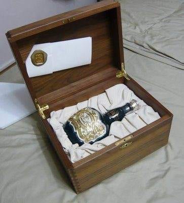 A luxurious wooden box showcasing a bottle of Chivas Regal Royal Salute.