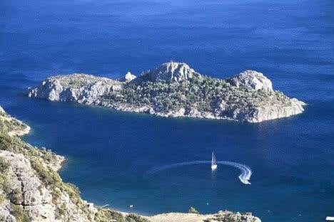 An exotic, private island holiday with a sailboat in the water.