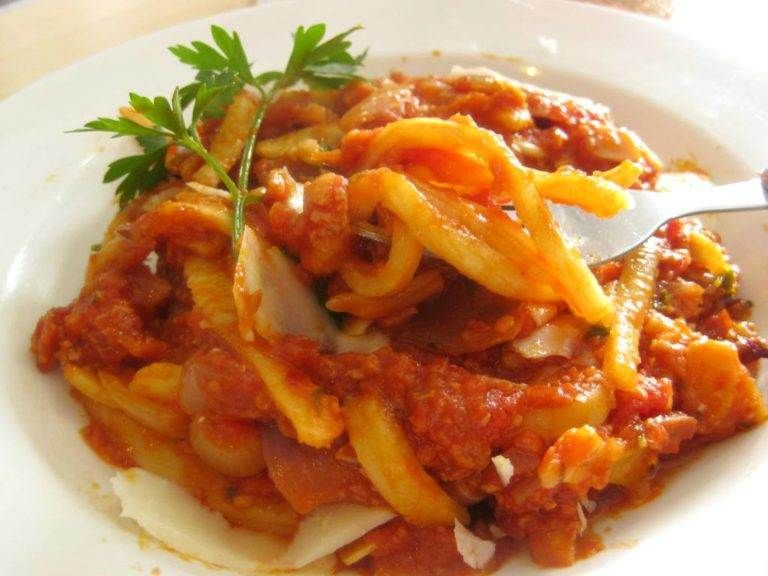 A plate of pasta with sauce from Contigiano.