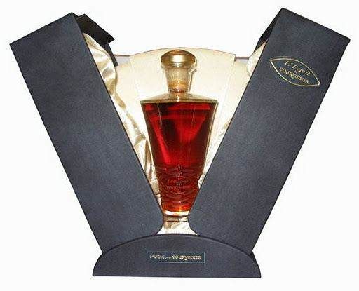 A bottle of red wine in a box with a crystal decanter.