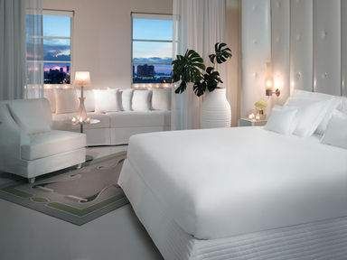 A white bedroom with a city view, try to touch the horizon from the top floor of Delano.