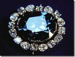 A brooch with a large black diamond and diamonds, inspired by the story of the Hope Diamond.