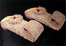 A pair of sandals adorned with intricate beaded patterns.