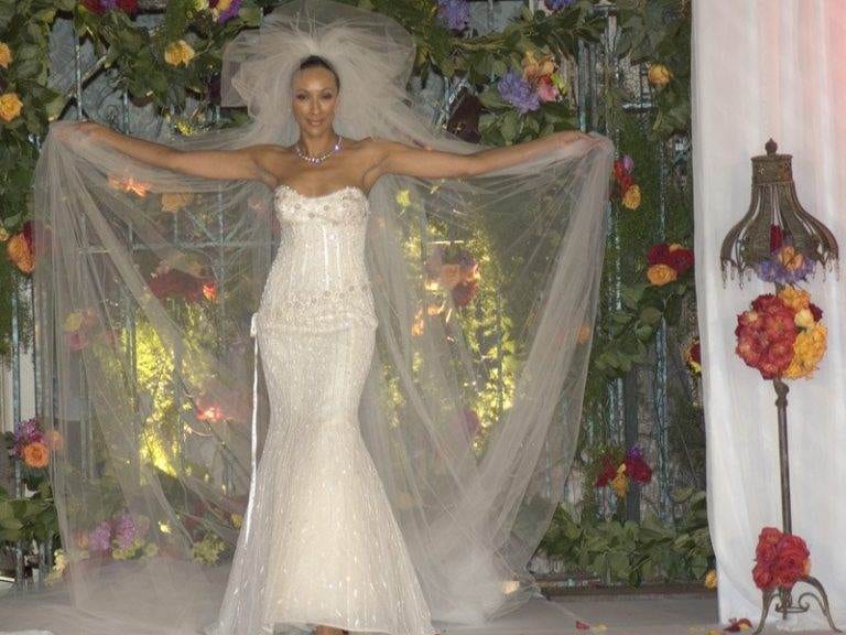 A woman wears a wedding dress while walking down the aisle for a diamond-studded wedding.