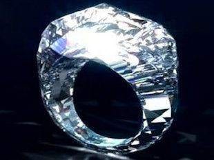 A diamond ring with a light shining through it - Shawish Jewelry