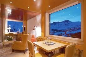Experience the heavenly Swiss style at the Tschuggen Grand Hotel, offering a living room with mountain views.
