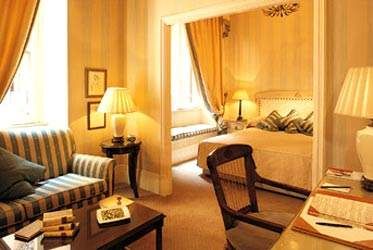 A hotel room with yellow walls and a bed offering cultural allure.