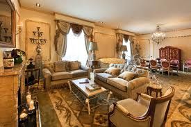 The Salvador Dali Suite at Hotel El Palace Barcelona is adorned with ornate furniture and features a fireplace.