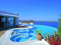 A luxurious villa with a swimming pool overlooking the ocean.