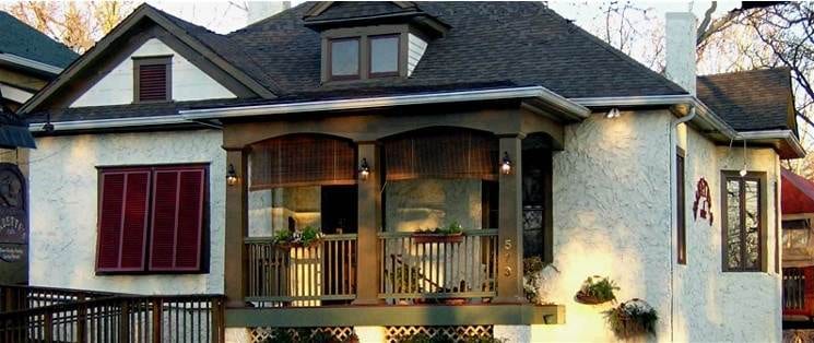 A house with a porch and shutters in Atlanta, GA.