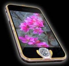A diamond adorned cell phone with a pink flower on it.