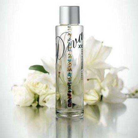 A bottle of perfume with white flowers fit for a diva.