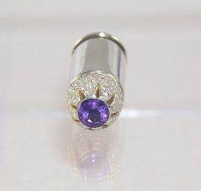 A purple amethyst and diamond ring with pendant.