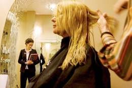 A woman at the salon getting her hair cut.