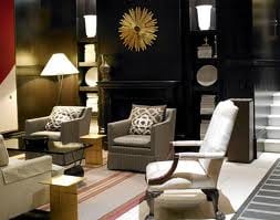 A black and white lobby with furniture and a clock at Fifteen Beacon Hotel in Boston.