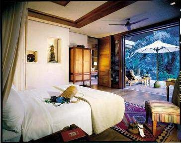 Enjoy a luxurious Indonesian lifestyle with a balcony overlooking a waterfall at Four Seasons Sayan Bali.