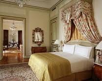 A luxurious bedroom with a king-sized bed and opulent decor.