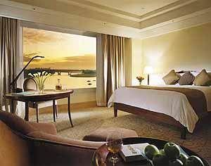 A luxurious room with a view at Fullerton Hotel.